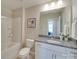 Well-lit bathroom featuring a granite countertop vanity and shower-tub combination at 574 Altamonte Dr, Clover, SC 29710