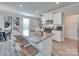 Modern kitchen island featuring barstool seating, sleek countertops, and a view of the kitchen and dining area at 574 Altamonte Dr, Clover, SC 29710