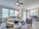 Inviting living area with ample natural light, cozy seating, and an open layout flowing to the dining area at 574 Altamonte Dr, Clover, SC 29710