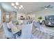 Open-concept living room showcasing modern decor, an elegant chandelier, and seamless flow to the kitchen at 574 Altamonte Dr, Clover, SC 29710