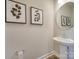 Stylish powder room featuring a pedestal sink, modern fixtures, and contemporary decor at 574 Altamonte Dr, Clover, SC 29710