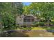 Exterior view of home with screened porch overlooking a peaceful pond at 5915 Mammoth Rd, Charlotte, NC 28270