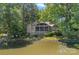 Waterfront home featuring a screened porch and meticulously manicured lawn, offering a peaceful and private retreat at 5915 Mammoth Rd, Charlotte, NC 28270