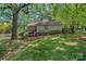 Charming backyard with a screened porch, waterfront, and lush greenery, perfect for outdoor entertaining and relaxation at 5915 Mammoth Rd, Charlotte, NC 28270