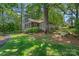 Stunning backyard with a screened porch, waterfront view, and meticulously manicured landscaping, creating a peaceful oasis at 5915 Mammoth Rd, Charlotte, NC 28270