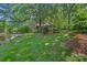 Spacious backyard with lush green grass leading to waterfront, perfect for relaxing and enjoying nature at 5915 Mammoth Rd, Charlotte, NC 28270