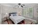 Cozy bedroom featuring a plush bed, decorative rug, and natural light from shuttered windows at 5915 Mammoth Rd, Charlotte, NC 28270