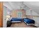 Attic bedroom with twin beds, built-in shelves, and natural light from the window at 5915 Mammoth Rd, Charlotte, NC 28270