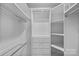 Bright, well-organized walk-in closet featuring shelving and hanging rods for optimal storage at 5915 Mammoth Rd, Charlotte, NC 28270