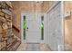 Inviting foyer with stone accents, tile flooring, and a staircase at 5915 Mammoth Rd, Charlotte, NC 28270