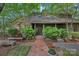 Charming stone facade home with a welcoming brick walkway and covered front entrance at 5915 Mammoth Rd, Charlotte, NC 28270