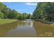 Picturesque pond featuring a tranquil fountain, surrounded by lush greenery, offering a serene and scenic view at 5915 Mammoth Rd, Charlotte, NC 28270