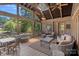 Relaxing screened-in porch with comfortable seating, ceiling fans, and views of the backyard and the lake at 5915 Mammoth Rd, Charlotte, NC 28270