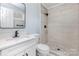 Modern bathroom featuring tiled shower, updated vanity with quartz countertop, and tiled floors at 6007 Charing Pl, Charlotte, NC 28211