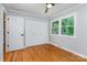 Bright bedroom with hardwood floors, neutral walls, closet for ample storage space and a window at 6007 Charing Pl, Charlotte, NC 28211