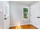 Bright entryway with hardwood floors, a window, and a white entry door at 6007 Charing Pl, Charlotte, NC 28211