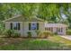Charming single-story home featuring a freshly painted exterior, well-maintained landscaping, and inviting curb appeal at 6007 Charing Pl, Charlotte, NC 28211