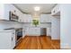 Beautiful kitchen featuring stainless steel appliances, white cabinetry, modern countertops, and ample natural light at 6007 Charing Pl, Charlotte, NC 28211