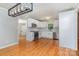 Newly renovated kitchen featuring white cabinets, stainless steel appliances, modern fixtures, and hardwood floors at 6007 Charing Pl, Charlotte, NC 28211