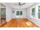 Bright living area with hardwood floors, natural light, and sliding glass doors that lead to the outdoor space at 6007 Charing Pl, Charlotte, NC 28211
