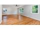 Bright living room with large windows, classic hardwood floors, and neutral paint providing a welcoming atmosphere at 6007 Charing Pl, Charlotte, NC 28211