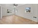 Spacious bedroom with hardwood floors and three windows offering ample natural light at 6706 Queensberry Dr, Charlotte, NC 28226