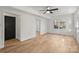 Open bedroom featuring light hardwood floors, ceiling fan, and natural light at 6706 Queensberry Dr, Charlotte, NC 28226