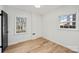 Bedroom with two windows offering natural light and wood-look floors at 6706 Queensberry Dr, Charlotte, NC 28226