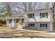 Charming two-story home with white siding, black shutters, and a light blue front door at 6706 Queensberry Dr, Charlotte, NC 28226