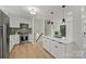 Modern kitchen with stainless steel appliances, quartz countertops, and ample natural light at 6706 Queensberry Dr, Charlotte, NC 28226