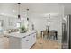 Bright kitchen with a quartz island, pendant lighting, and an open floorplan at 6706 Queensberry Dr, Charlotte, NC 28226