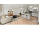 Open concept living room with modern decor and a breakfast bar with stools at 6706 Queensberry Dr, Charlotte, NC 28226