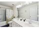 Well-lit bathroom featuring a double sink vanity, shower and tub combo, and neutral-toned walls at 6878 Spring Peeper Ln, Lancaster, SC 29720