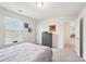 Bright bedroom featuring a window, a chest of drawers, and easy access to the hallway at 6878 Spring Peeper Ln, Lancaster, SC 29720