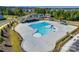 Aerial shot of a community pool with a lap pool, play area and ample deck space for residents to enjoy at 6878 Spring Peeper Ln, Lancaster, SC 29720