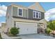 Charming two-story home with a manicured front yard, two car garage and beautiful stone accents at 6878 Spring Peeper Ln, Lancaster, SC 29720
