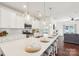 Bright kitchen with white cabinets, stainless steel appliances, and a large island with seating at 6878 Spring Peeper Ln, Lancaster, SC 29720