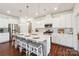 Bright kitchen with white cabinets, stainless steel appliances, and a large island with seating at 6878 Spring Peeper Ln, Lancaster, SC 29720
