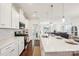 Bright kitchen with white cabinets, stainless steel appliances, and a large island with seating at 6878 Spring Peeper Ln, Lancaster, SC 29720