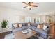 Comfortable living room area with a gray sectional sofa, hardwood floors and large windows at 6878 Spring Peeper Ln, Lancaster, SC 29720