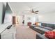 Spacious living room with a large sectional, TV, and neutral carpet flooring at 6878 Spring Peeper Ln, Lancaster, SC 29720