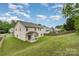 Inviting backyard featuring a covered porch and well-maintained lawn, perfect for outdoor activities at 7031 Woodbridge Valley Cir, Charlotte, NC 28227