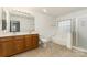 Spacious bathroom offering a double vanity, shower, tub and tile floors at 7031 Woodbridge Valley Cir, Charlotte, NC 28227