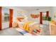 This staged bedroom features colorful accents, including artwork and playthings at 7031 Woodbridge Valley Cir, Charlotte, NC 28227