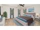 Sun-filled bedroom with modern decor featuring hardwood floors and large windows at 7031 Woodbridge Valley Cir, Charlotte, NC 28227