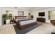 This primary bedroom boasts ample natural light, a TV, a dresser, and a relaxing color scheme at 7031 Woodbridge Valley Cir, Charlotte, NC 28227