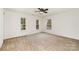 This bedroom features carpeting and multiple windows for ample light at 7031 Woodbridge Valley Cir, Charlotte, NC 28227