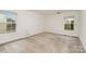 Empty bedroom with carpet flooring, white walls, and windows at 7031 Woodbridge Valley Cir, Charlotte, NC 28227