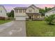 Charming two-story home featuring a spacious lawn, a two-car garage, and a welcoming front porch at 7031 Woodbridge Valley Cir, Charlotte, NC 28227