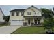 Charming two-story home featuring a well-maintained lawn and attached two-car garage at 7031 Woodbridge Valley Cir, Charlotte, NC 28227